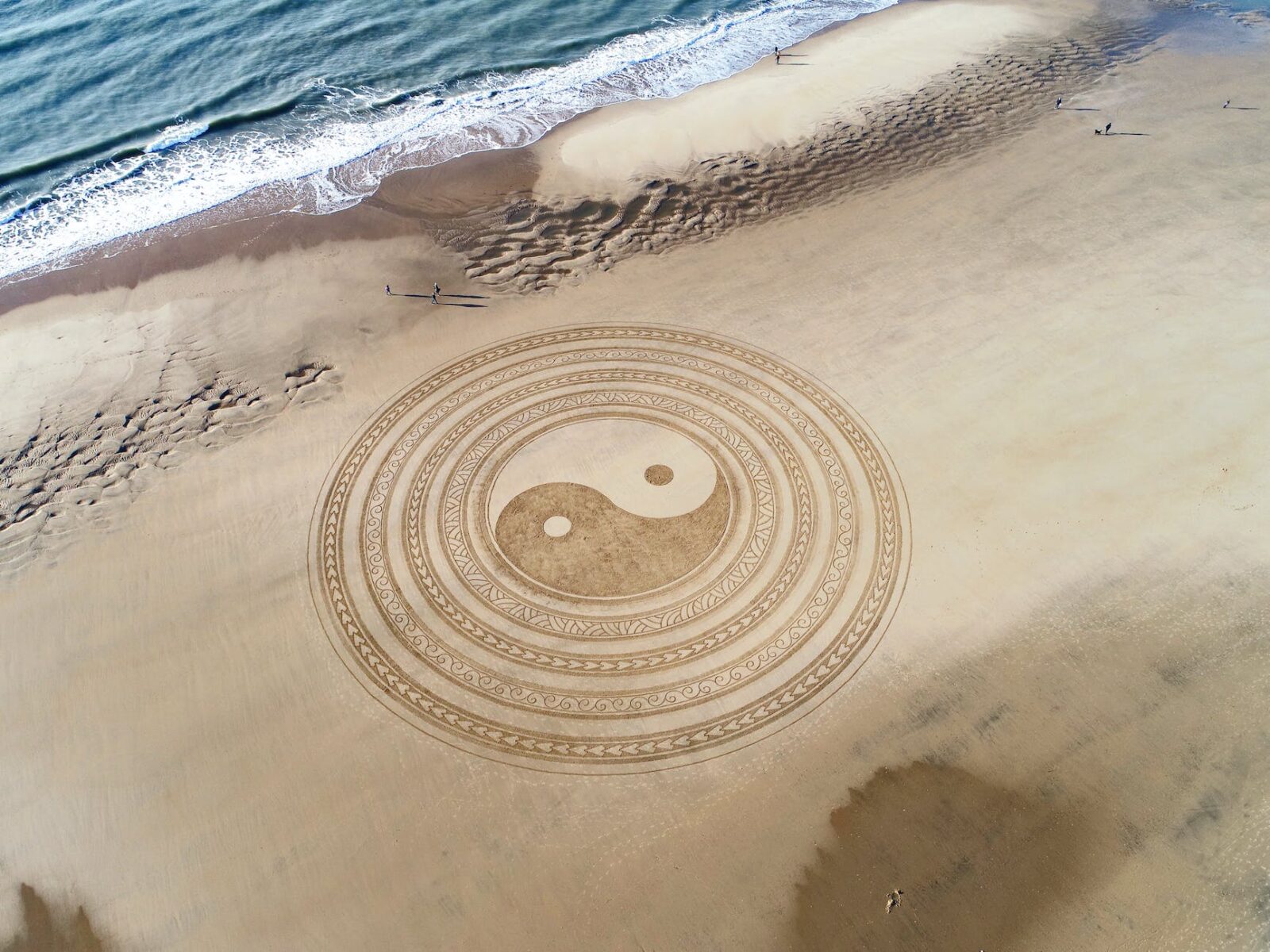 yin yang symbol on brown beach sand,Yin and Yang